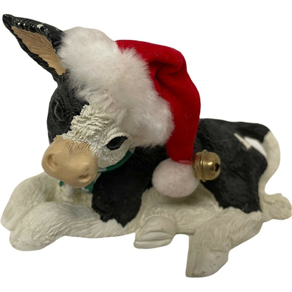 Enesco Black & White Cow Lying Santa Hat Green and White Heart Scarf 3" x 5"